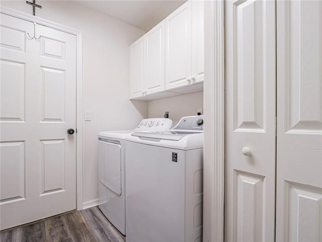 laundry area featuring dark hardwood / wood-style flooring, cabinets, and washer and dryer