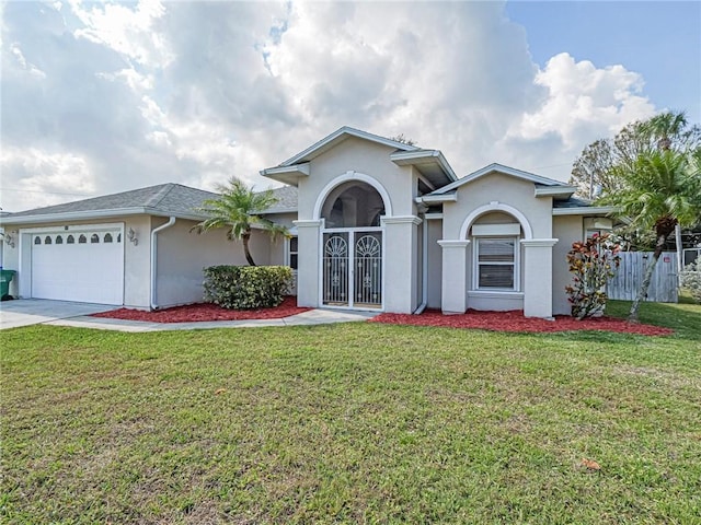 view of front of home with a garage and a front lawn