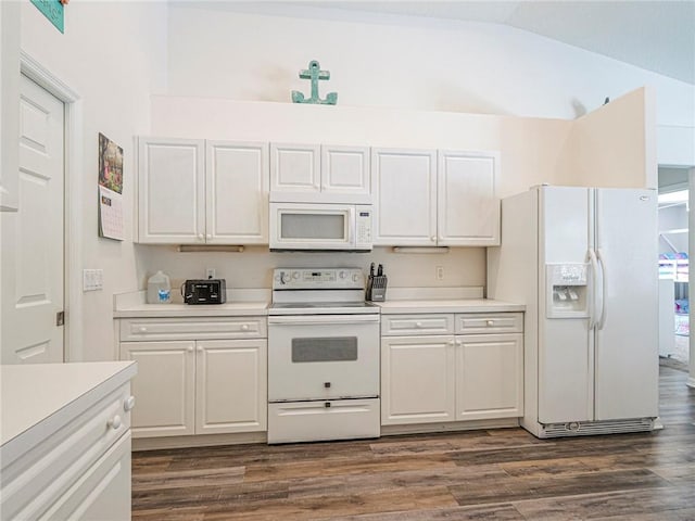 kitchen featuring white cabinetry, vaulted ceiling, and white appliances