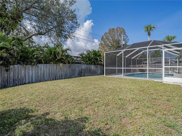 view of yard with a lanai and a fenced in pool