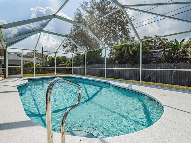 view of pool featuring a patio and glass enclosure