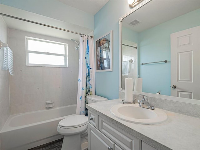 full bathroom featuring shower / tub combo with curtain, vanity, and toilet