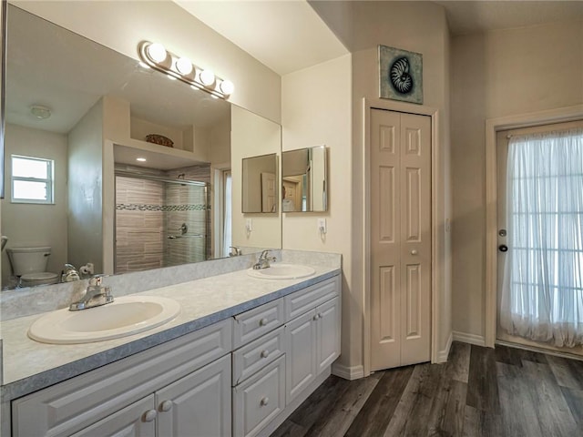 bathroom with vanity, hardwood / wood-style floors, toilet, and walk in shower