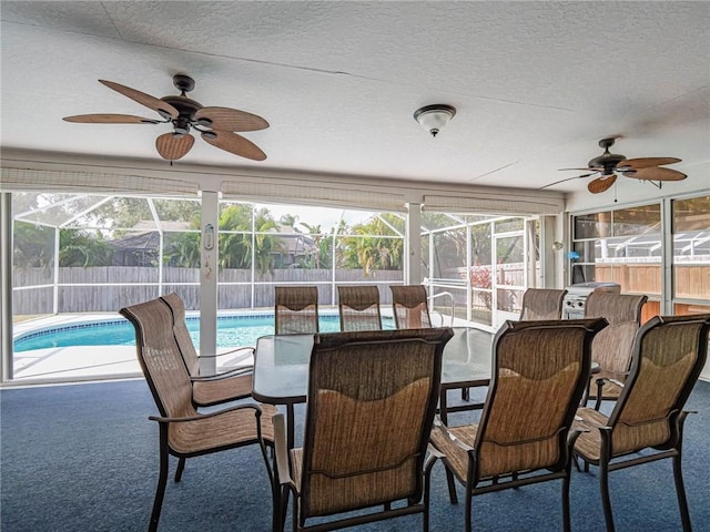 sunroom / solarium featuring ceiling fan