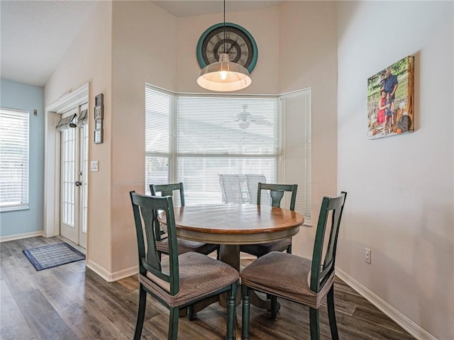 dining area with lofted ceiling and dark hardwood / wood-style floors