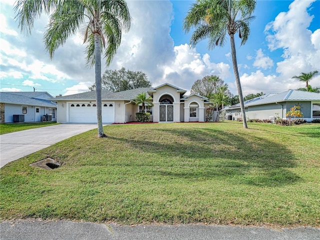 single story home featuring a garage, a front lawn, and central air condition unit