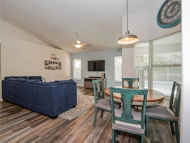 dining space with vaulted ceiling, dark hardwood / wood-style floors, and ceiling fan