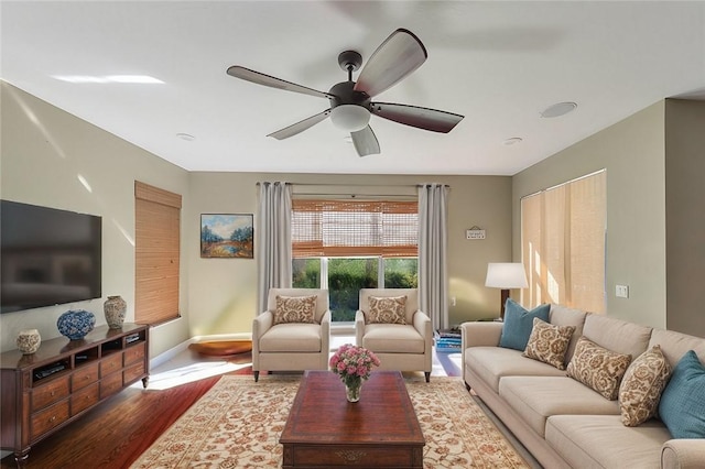 living room with ceiling fan and dark hardwood / wood-style floors