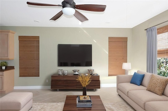 living room with light tile patterned floors and ceiling fan