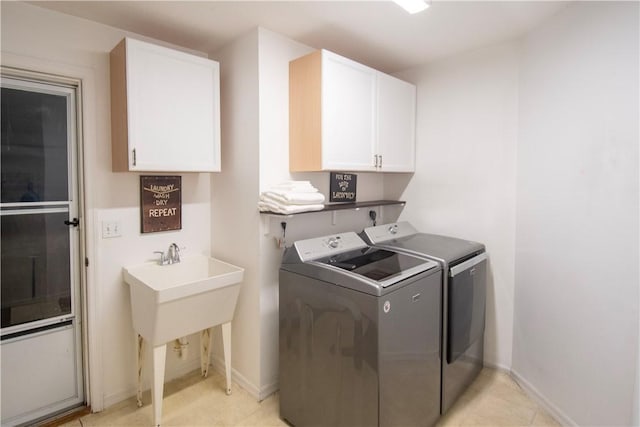 1018 Persian Ln, Sebastian, FL 32958 - washroom featuring washing machine and dryer, cabinet space, and light tile patterned flooring