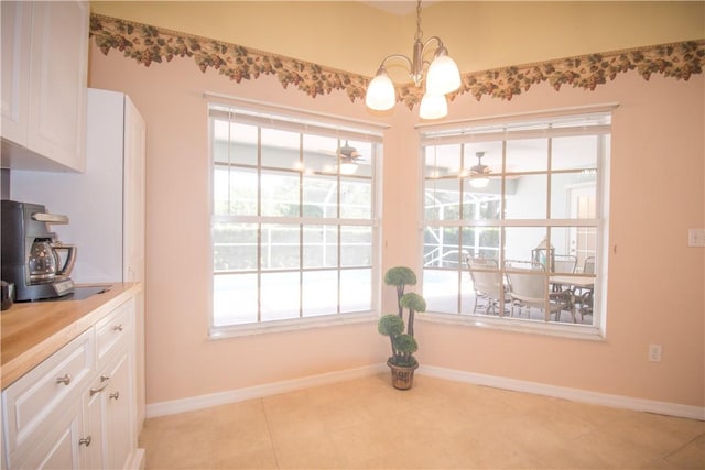 1018 Persian Ln, Sebastian, FL 32958 - dining area featuring a chandelier, healthy amount of natural light, and light tile patterned floors