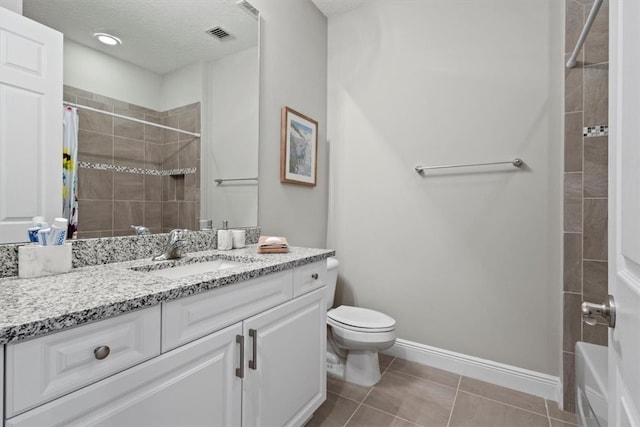 full bathroom featuring tile patterned flooring, shower / tub combo, a textured ceiling, vanity, and toilet