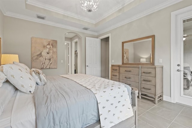 tiled bedroom with an inviting chandelier, ornamental molding, and a raised ceiling