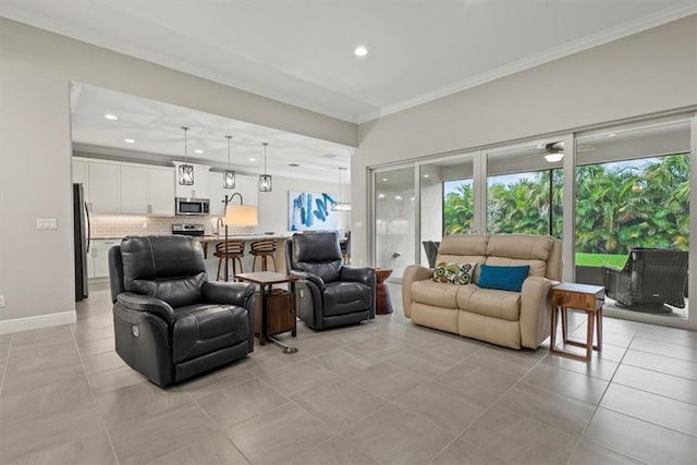 living room featuring light tile patterned flooring, ceiling fan, and ornamental molding