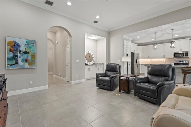 living room featuring light tile patterned floors and crown molding