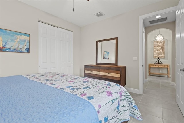 tiled bedroom featuring a closet