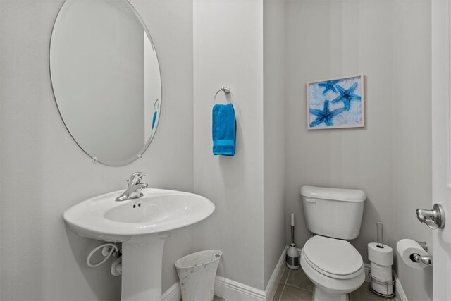 bathroom with tile patterned floors and toilet