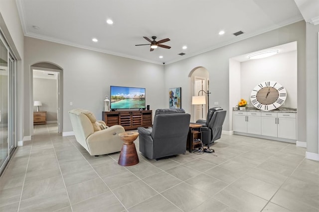 tiled living room with ornamental molding and ceiling fan