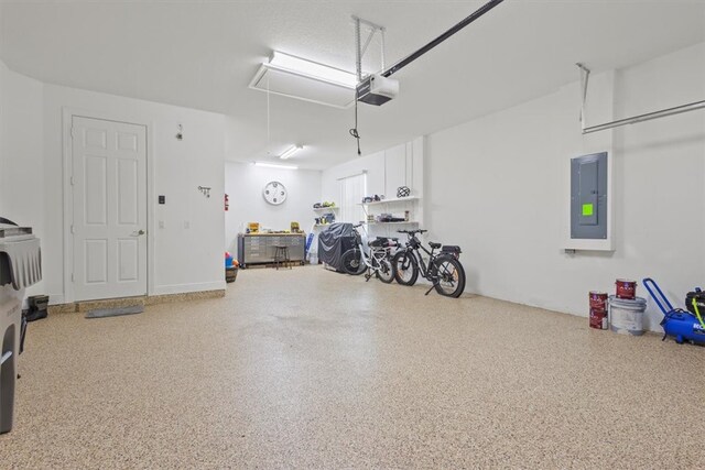 garage with electric panel and a garage door opener