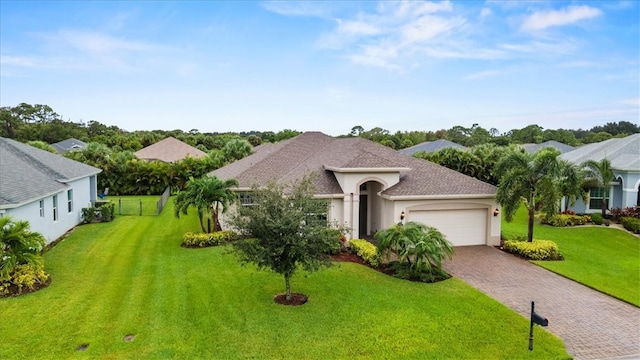 view of front facade with a garage and a front lawn