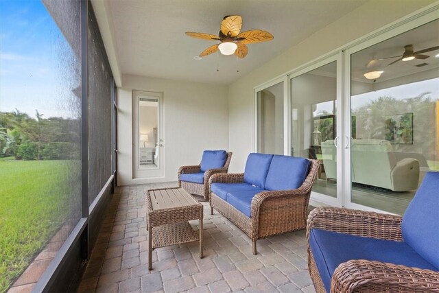 sunroom / solarium featuring ceiling fan