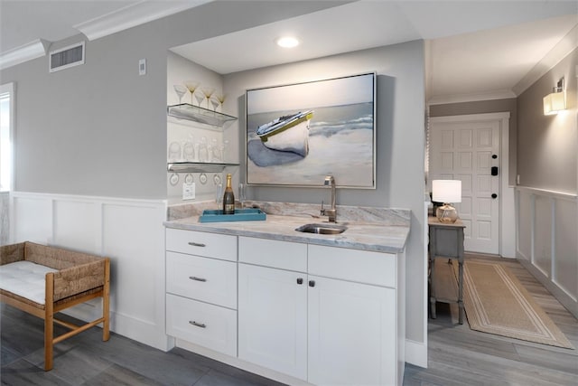 bathroom featuring vanity, hardwood / wood-style flooring, and crown molding