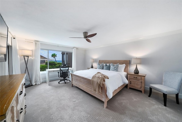 bedroom with carpet flooring, ceiling fan, and crown molding