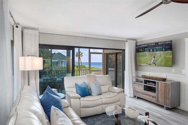 living room featuring ceiling fan and light hardwood / wood-style floors