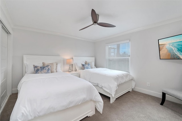 bedroom featuring ornamental molding, carpet, ceiling fan, and a closet