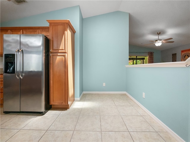 kitchen with ceiling fan, light tile patterned flooring, stainless steel fridge with ice dispenser, and vaulted ceiling