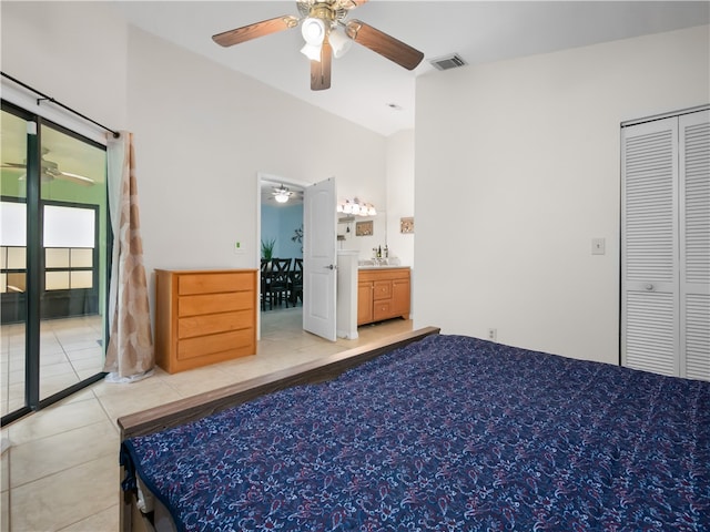 bedroom with ceiling fan, light tile patterned floors, a closet, and vaulted ceiling