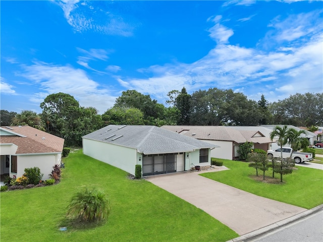 ranch-style home featuring a front lawn and a garage