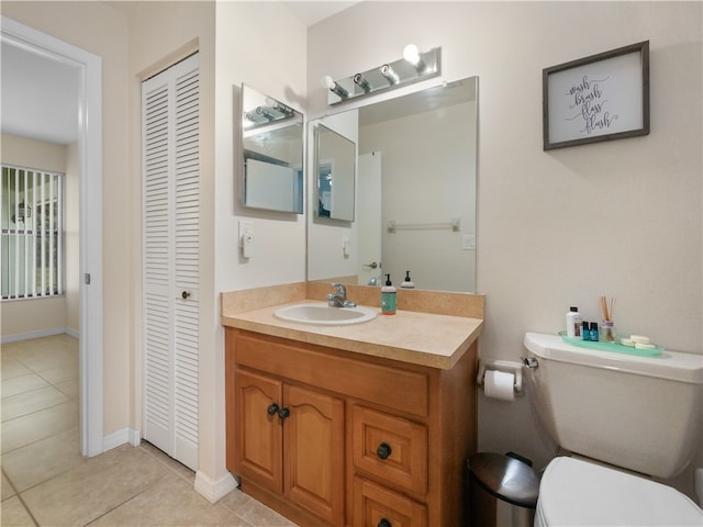 bathroom featuring tile patterned flooring, vanity, and toilet