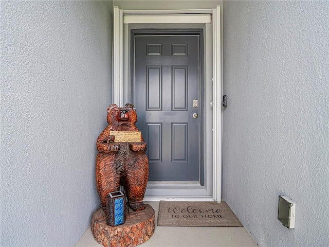 doorway to property with stucco siding