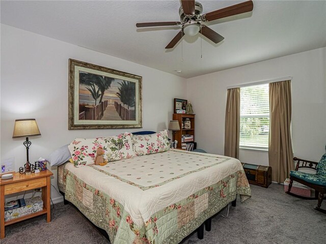 bedroom with ceiling fan, baseboards, and carpet flooring