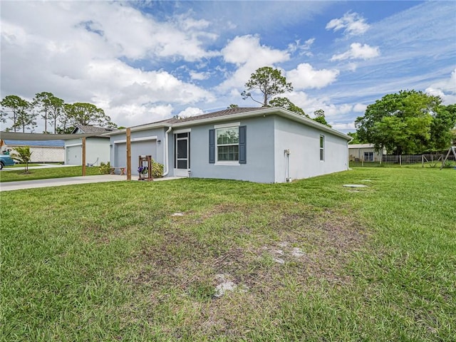 single story home with a garage, concrete driveway, fence, a front lawn, and stucco siding