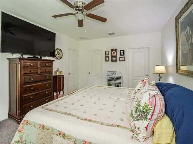 bedroom with ceiling fan, carpet floors, and visible vents