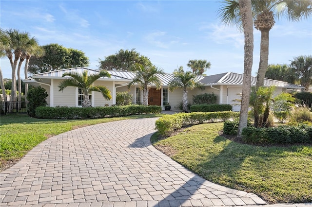 ranch-style home with a front yard and a garage