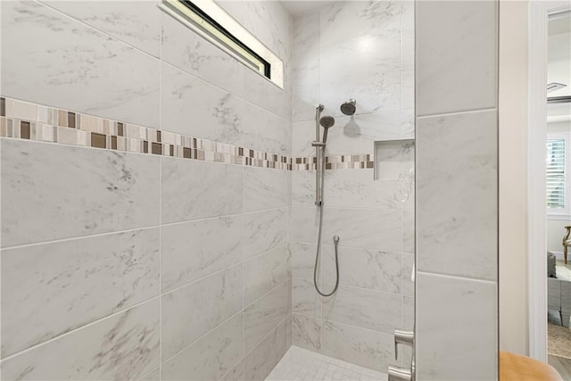 bathroom with a tile shower