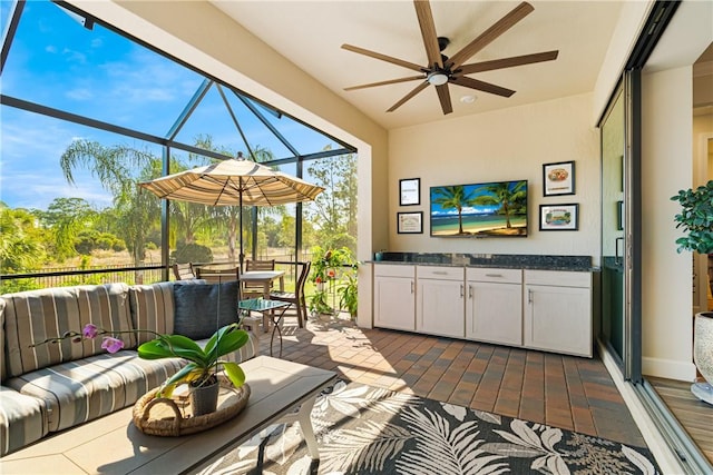 sunroom / solarium featuring ceiling fan