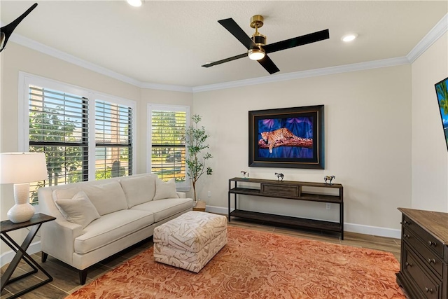 living room featuring crown molding, ceiling fan, and hardwood / wood-style flooring