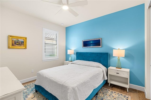 bedroom with hardwood / wood-style flooring and ceiling fan