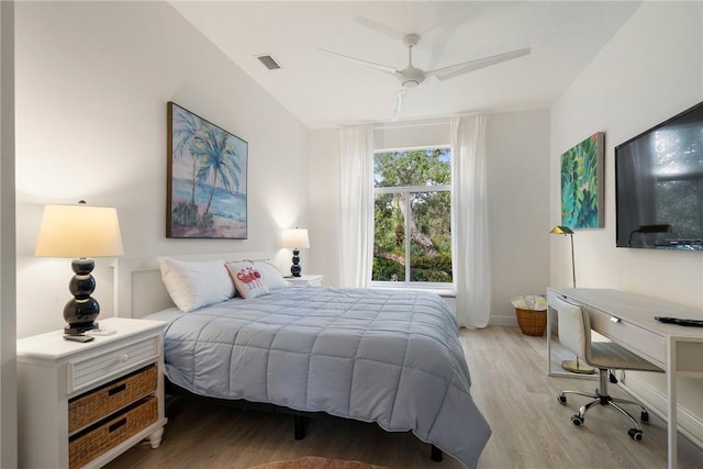 bedroom with ceiling fan, visible vents, baseboards, and wood finished floors