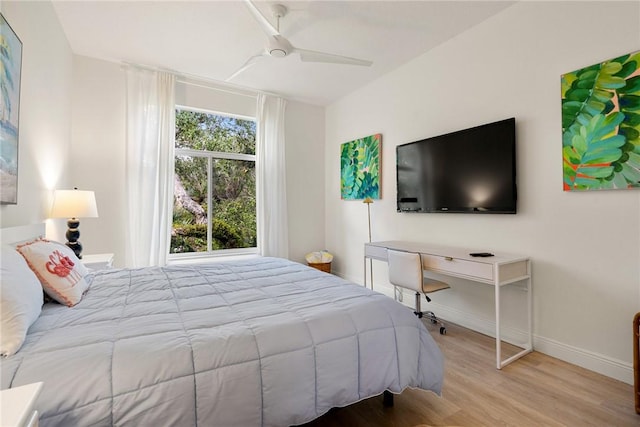 bedroom with baseboards, wood finished floors, and a ceiling fan