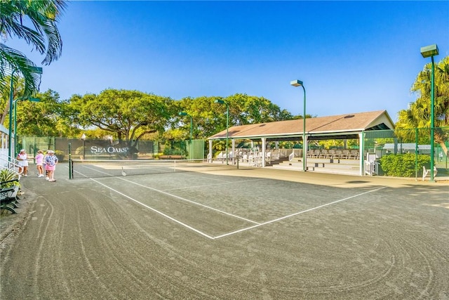 view of tennis court featuring fence