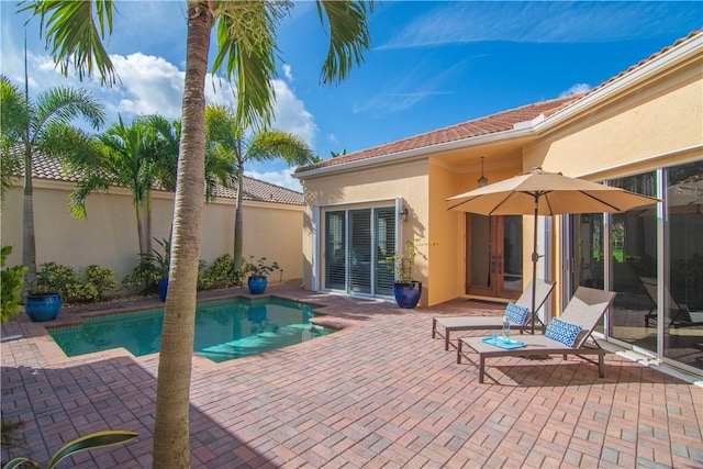 view of pool featuring french doors and a patio