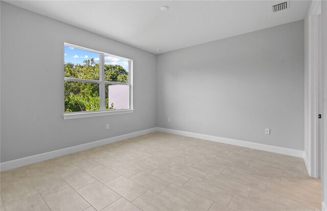 1279 Harper Way Unit 013, Vero Beach, FL 32960 - spare room with baseboards and light tile patterned floors