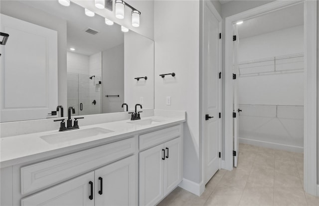 1279 Harper Way Unit 013, Vero Beach, FL 32960 - full bath featuring a stall shower, double vanity, a spacious closet, tile patterned floors, and baseboards