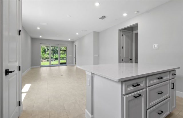 1279 Harper Way Unit 013, Vero Beach, FL 32960 - kitchen featuring open floor plan, recessed lighting, baseboards, gray cabinetry, and a kitchen island