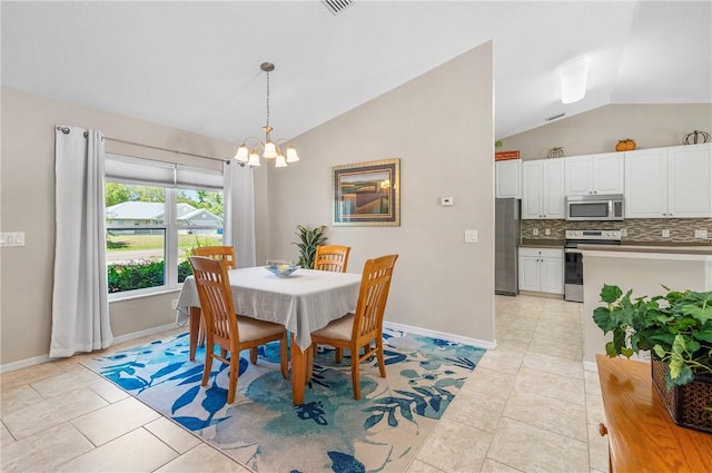 dining space featuring baseboards, an inviting chandelier, light tile patterned flooring, and vaulted ceiling